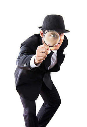 businessman looking for truth with magnifying glass